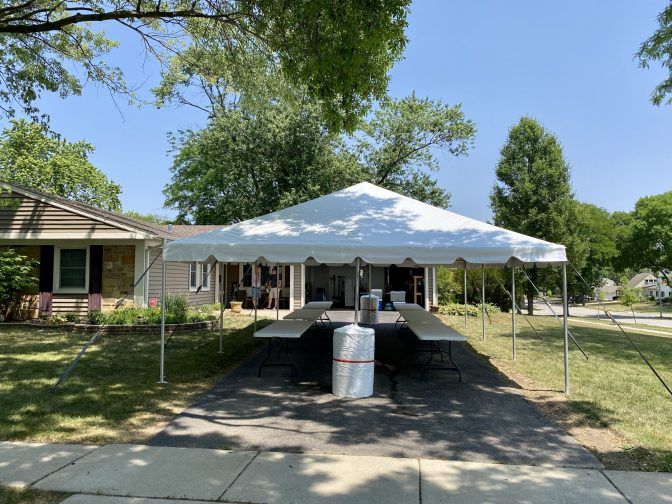 20x30 frame tent setup on a driveway