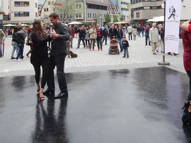 Black dance floor with people dancing outdoors