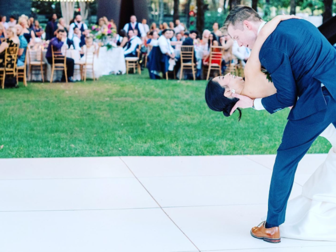 Couple dancing on a white dance floor outside